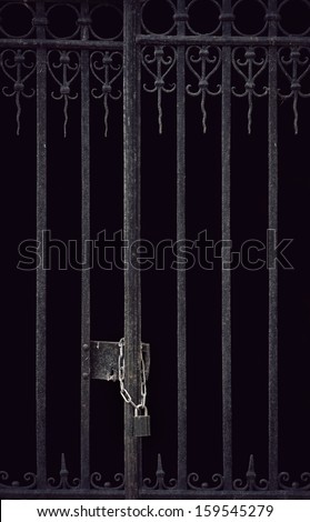 Door with metal bars locked with chain and padlock