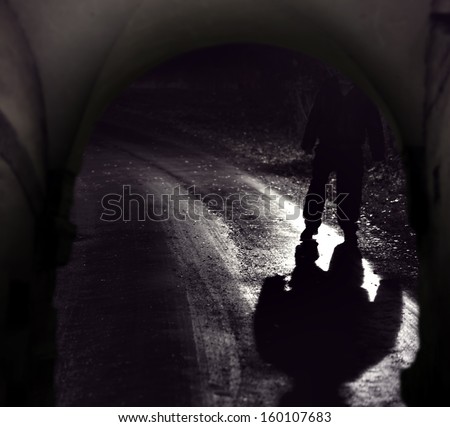 Scary person with dark shadow seen through vault