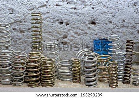 close up of metal springs on shelf in workshop
