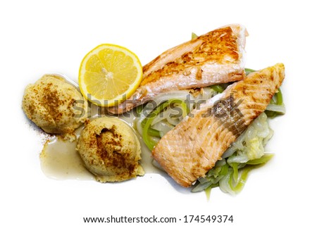 Swedish or Norwegian dish with fried salmon, mashed potatoes and a slice of lemon, isolated on white