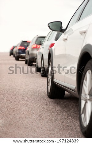 Long queue of cars on asphalt road