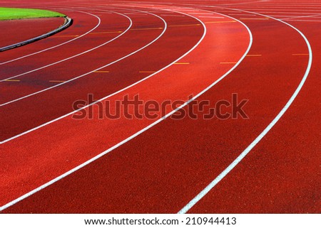 Curve of running tracks in athletics stadium, one lane highlighted