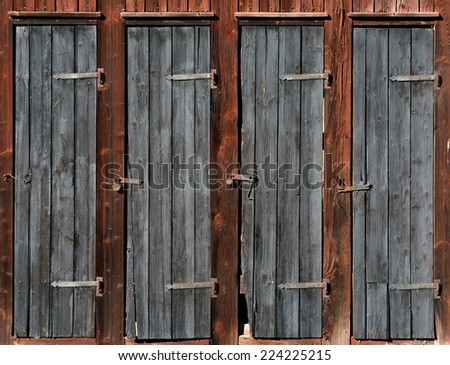 Row of doors on wooden shed in bad condition