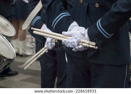 Hands of men in marching band with drum sticks