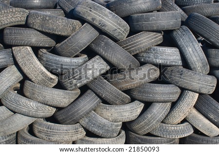 Stack of tires at a junk yard.