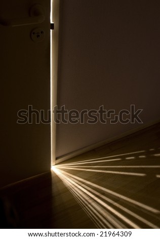 Sunlight shining through a small gap between the door an the wall, creating a pattern on the floor.