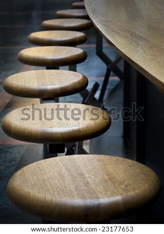 Bar-stools in a row by the counter.