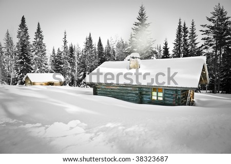 Remote log cabin in untouched snow
