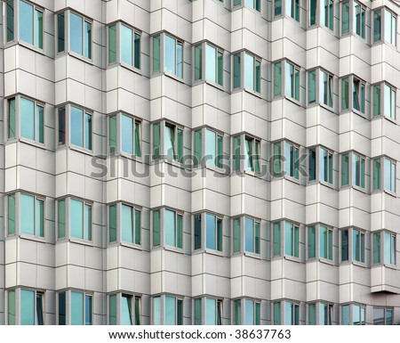 Background with facade of an office building with many windows