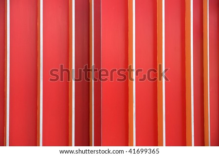 Background consisting of metal bars painted in different shades of red.