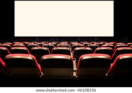 Backs of empty red seats in a movie theater with a white screen