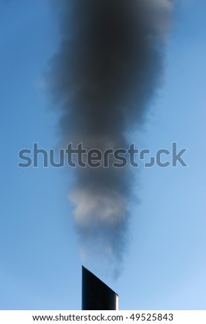 dark smoke coming out of a chimney, causing pollution