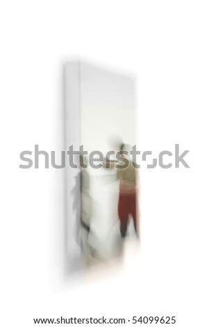 Blurred image of two people reflected in a mirror on a wall
