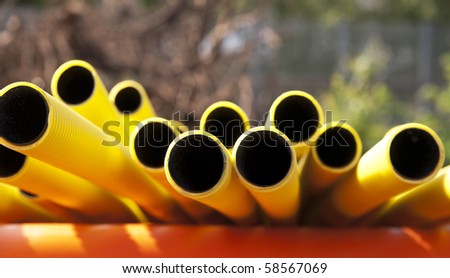 Yellow plastic pipes in sunshine