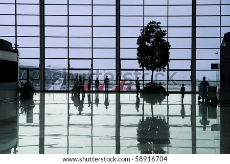 People waiting in the departure hall of a modern airport