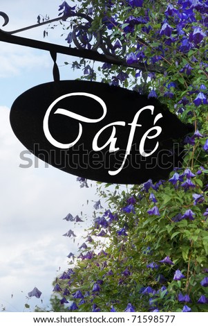 Cafe sign with blue or purple flowers