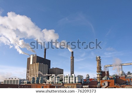 Factory with smoke on blue sky