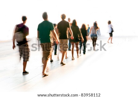 Blurred young people in casual dresses walking in a line