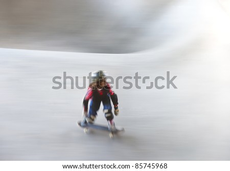 Young girl on skateboard in blurred motion