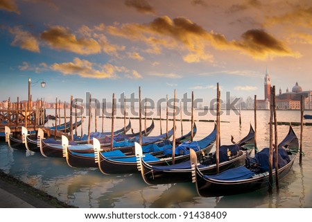 Moored gondolas in a row in evening light in Venice, Italy