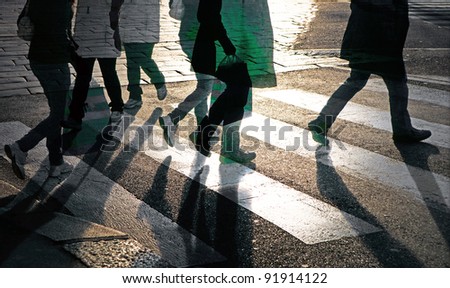 Silhouettes of people at pedestrian crossing