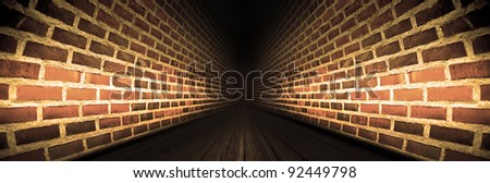 Tunnel with brick walls and wooden floor and diminishing perspective