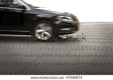 Black car at high speed on paved street