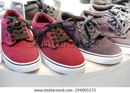 red sneakers on display in shoe shop