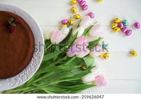 Easter Chocolate Eggs, Tulips and Homemade Chocolate Cake on Cake Stand