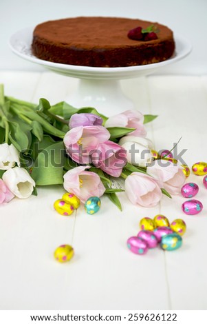 Easter Chocolate Eggs, Tulips and Homemade Chocolate Cake on Cake Stand
