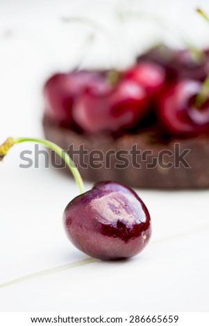 Homemade Raw Vegan Cherry Tart with Cherry on the foreground, macro shot, selective focus, shallow DOF