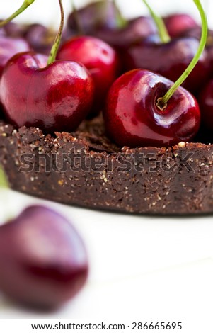 Homemade Raw Vegan Cherry Tart with Cherry on the foreground, macro shot, selective focus, shallow DOF