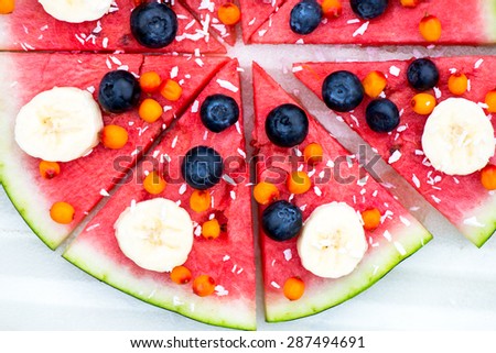 Vegan Snack from Watermelon, Fruits and Berries - blueberry, shredded coconut, bananas,  Seabuckthorn berries