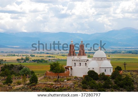 Chapel of All Saints in San Luis, Colorado, overlooking a view of fields