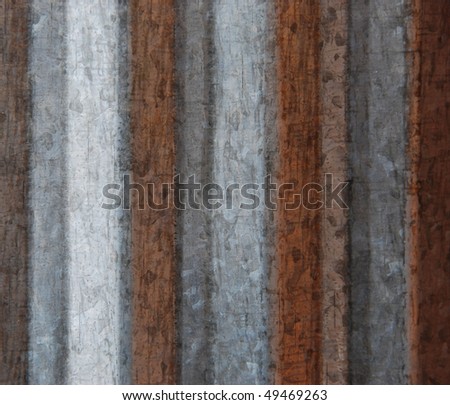 Grunge background in gray, brown and silver vertical stripes from the side of a corrugated metal cylindrical object, with light variance from light to dark going left to right
