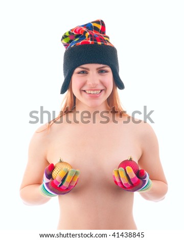 Young strawberry blond woman in winter cap and gloves holding colorful bauble christmas decorations