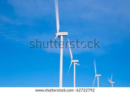 Wind turbines with fast moving blades blurred with long exposure