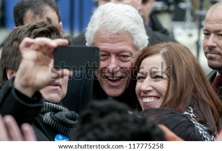PITTSBURGH, PA - NOVEMBER 5:  Former President Bill Clinton poses with attendees of a rally while campaigning for Barack Obama in Pittsburgh, PA on November 5, 2012.