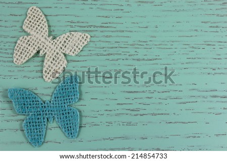 Jute butterfly shapes on a duck egg blue distressed wood background.