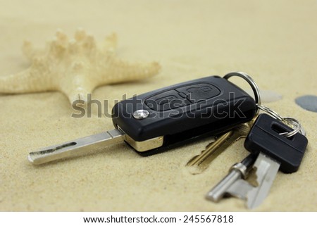 Car and house keys lost on the sand. Close up. Macro.