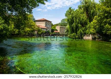 Avignon Lake & Houses.  Stucco Houses with a Red Roof in France.  An Emerald Green Lake.