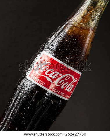 San Francisco, CA - February 4, 2015:  Photo of a glass bottle of Coca Cola - Refreshing.  Wet with water ice droplets.