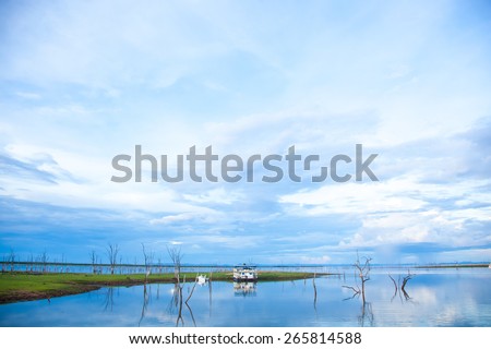 Lake Kariba Dam. Reflections On the Water.  House Boat and Clouds.