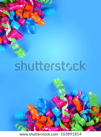 A bright colorful party streamer background. Birthday Swirls are in each corner on a blue background. Add your text to the copyspace area.