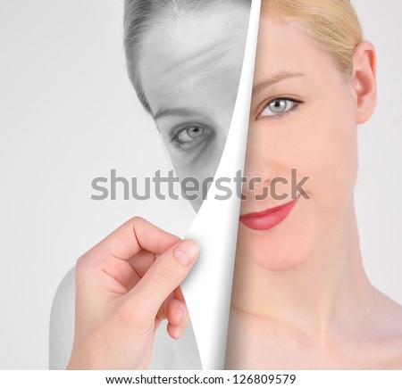 A hand is turning a paper of a young, eye on a wrinkled woman's face in black and white for a youth concept.