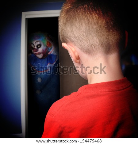 A scary clown is coming out of a boys closet in his bedroom at night for a nightmare or scary concept.