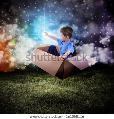 A young boy is sitting in a cardboard box and floating in the night sky reaching for a star in space.