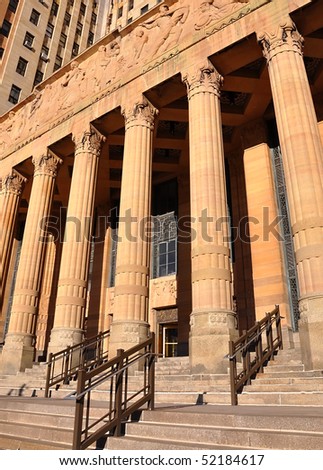 A city courthouse law building with pillar columns and stairs outside. Can represent law, justice or legislation. There is a gold rustic saturation.