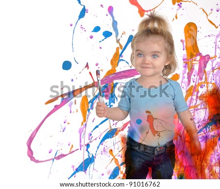 A young child is painting splatters of messy paint on a white background. Use it for a art or creativity concept.