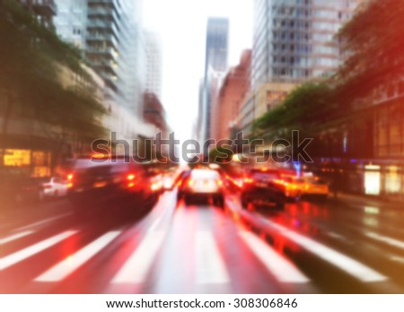 Busy traffic cars are driving in the city street with a blurred effect for a background transportation concept.